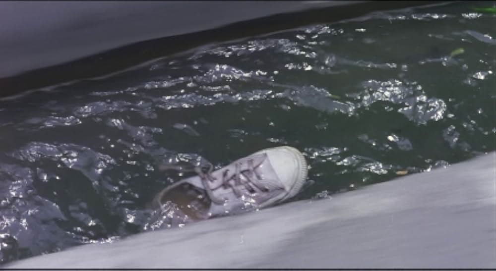 運動靴と赤い金魚の画像